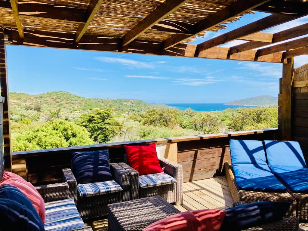 a balcony with chairs and a view of the ocean at Appartement Cemiliana in Bonifacio