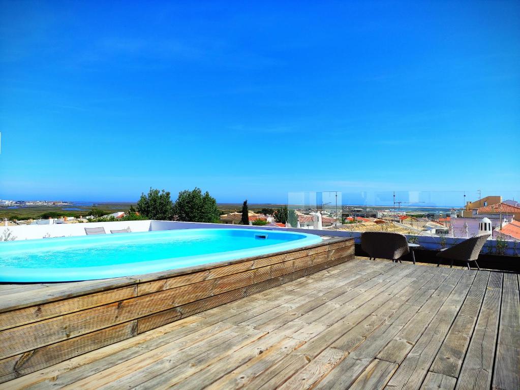 a swimming pool on the roof of a house at Apartamento Rooftop Montenegro in Faro