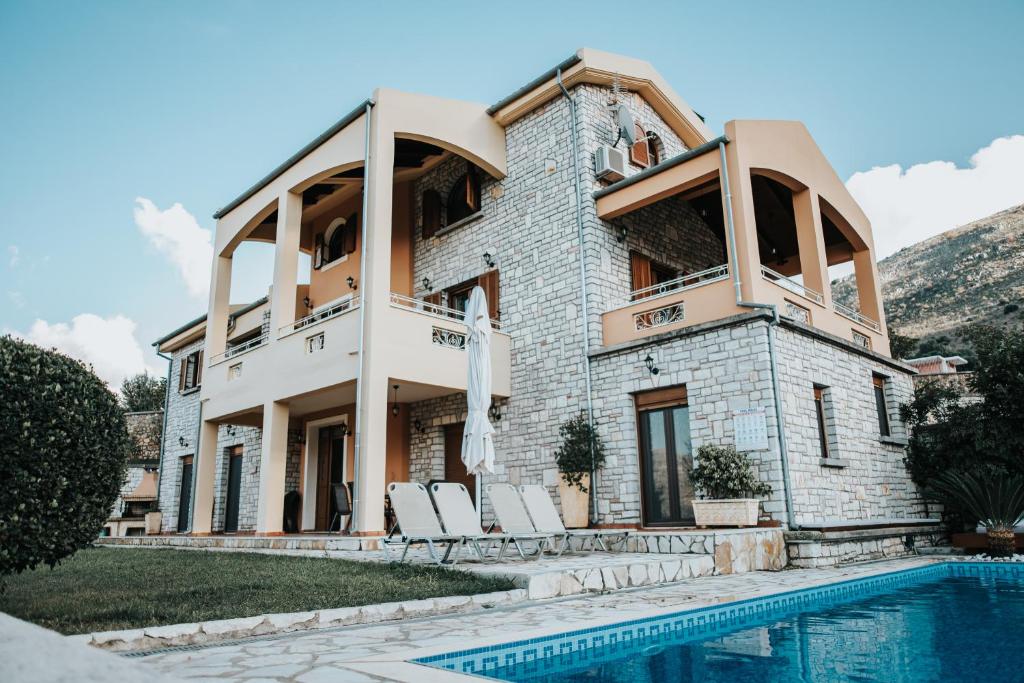 a house with a pool in front of it at Villa Milena in Syvota
