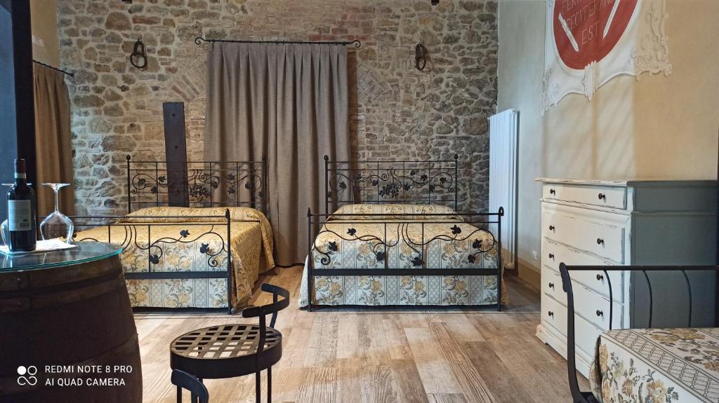 1 dormitorio con 2 camas y vestidor en Rocca degli Olivi, en San Gimignano