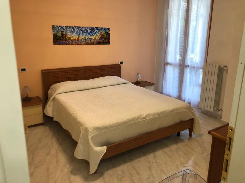 a bedroom with a bed and a painting on the wall at Riomaggiore Apartment cà di Euro in Riomaggiore