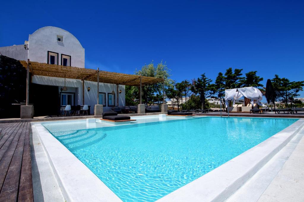 a large swimming pool in front of a building at A&V Sea View Villa in Fira