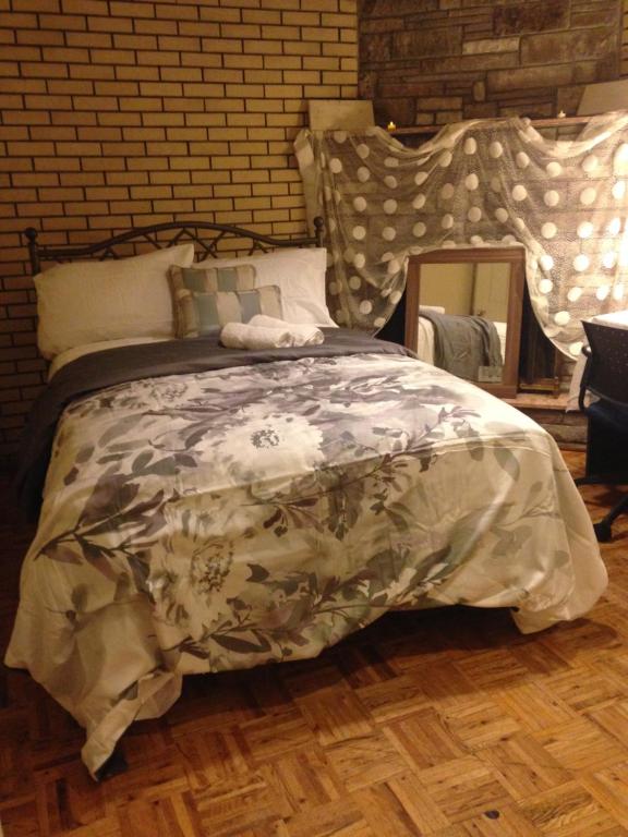 a bedroom with a bed and a brick wall at Apt Near Downtown in Montréal