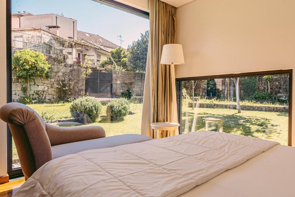 Postel nebo postele na pokoji v ubytování Casa das Mourôas