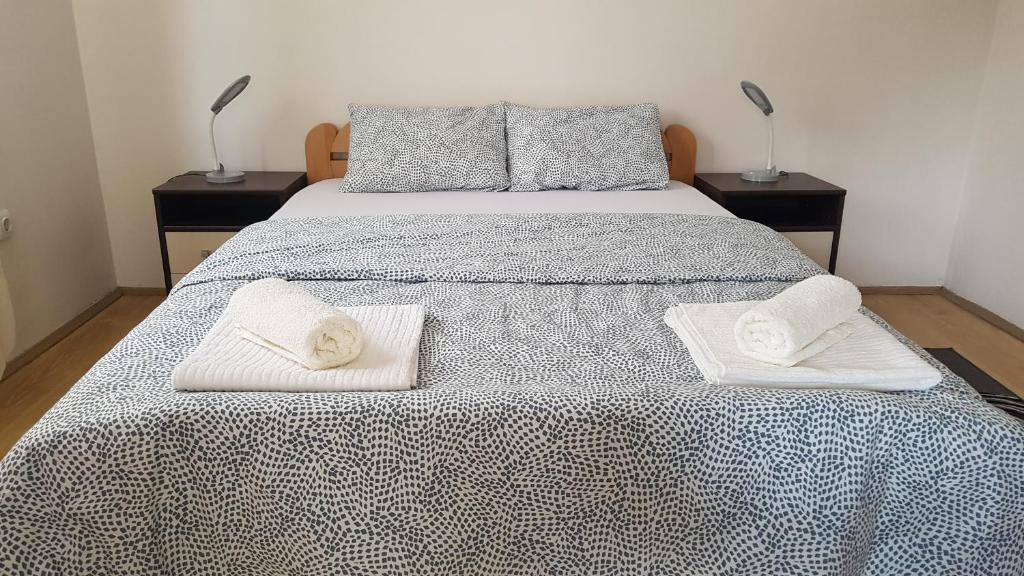 a bedroom with a bed with two towels on it at Apartman Jovanović in Bajina Bašta