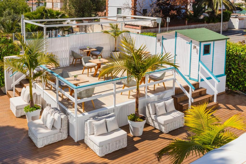 a deck with chairs and a tiny house at Antonio's House in Sitges