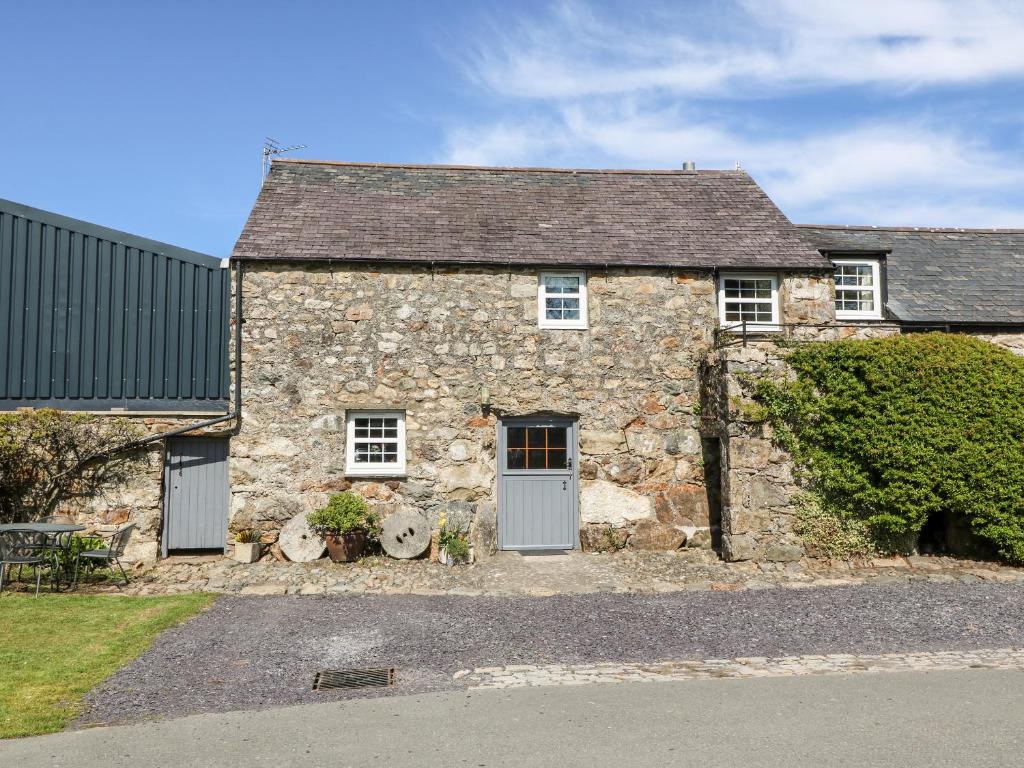 an old stone house with two doors at Stable 2 in Llanbedrog