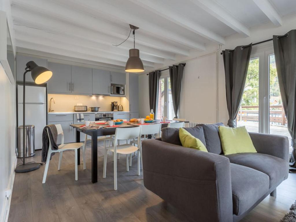 a living room and kitchen with a couch and a table at Appartement Les Deux Alpes, 5 pièces, 8 personnes - FR-1-348-242 in Les Deux Alpes