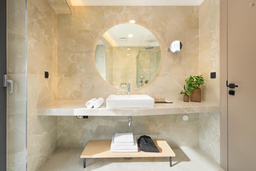a bathroom with a sink and a mirror at Boutique Hotel Porto in Dubrovnik