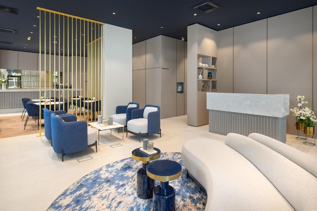 a lobby with a couch and chairs and a table at Boutique Hotel Porto in Dubrovnik