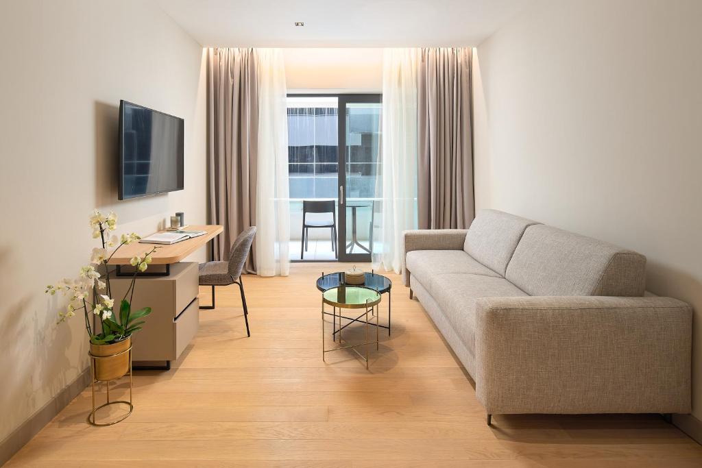 a living room with a couch and a table at Boutique Hotel Porto in Dubrovnik