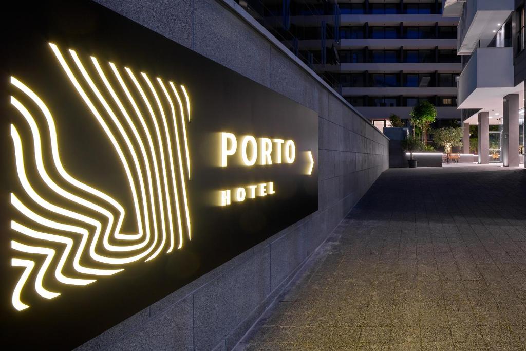 a neon sign for a porto hotel on a wall at Boutique Hotel Porto in Dubrovnik
