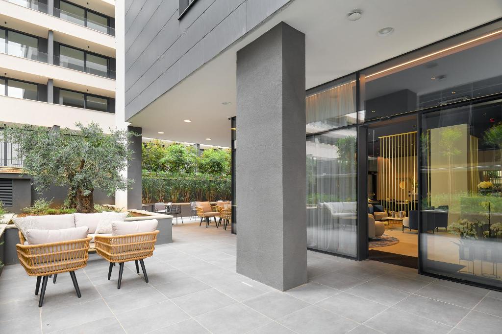 a courtyard with chairs and tables in a building at Boutique Hotel Porto in Dubrovnik