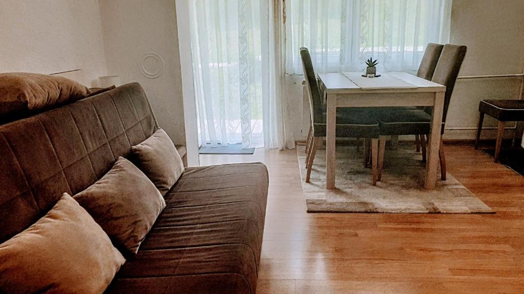 a living room with a couch and a table at Apartment Near the Lakes in Plitvička Jezera