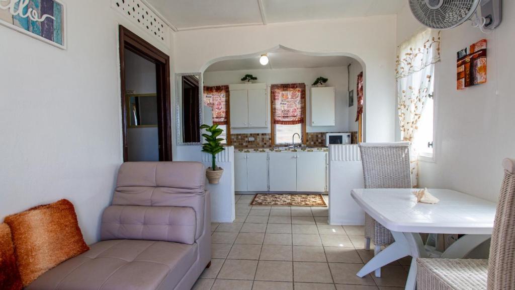 a living room with a couch and a table at Moonlight Cottage in East End Village