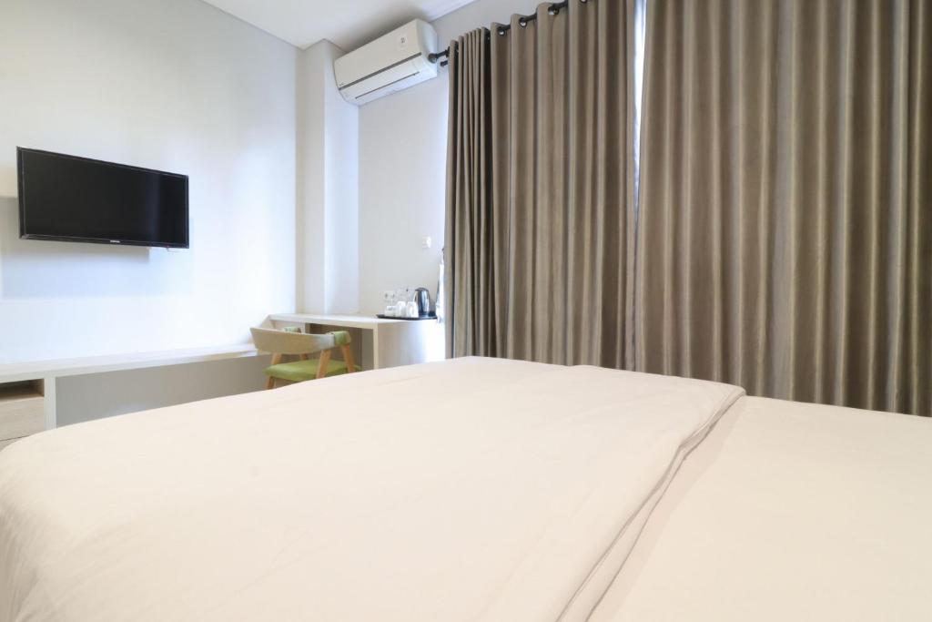 Postel nebo postele na pokoji v ubytování Mendjangan Residence