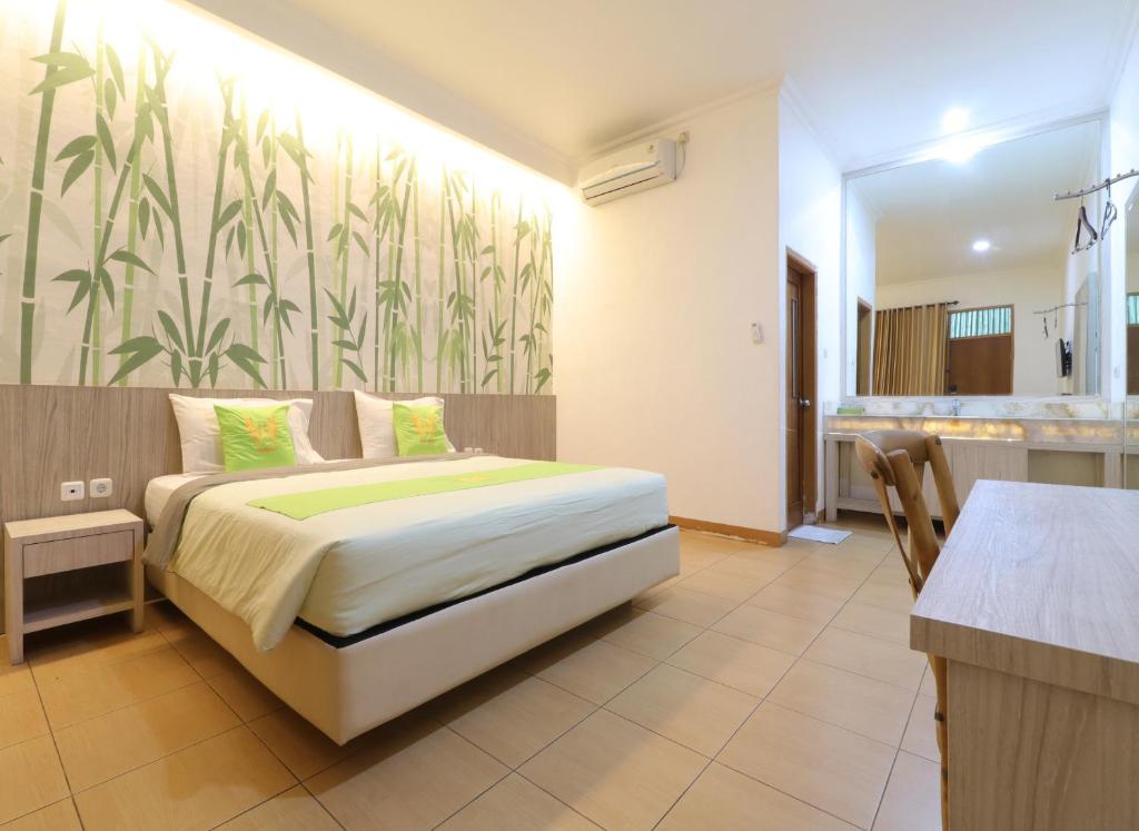 a hotel room with a bed and a bathroom at Hotel Huswah Airport in Tangerang
