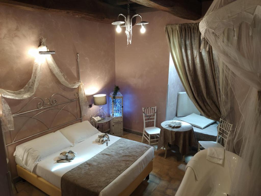 Postel nebo postele na pokoji v ubytování Relais Castrum Boccea