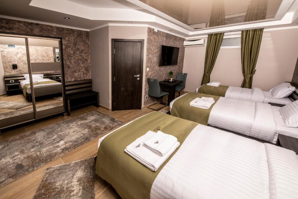 Postel nebo postele na pokoji v ubytování Hotel Novotheos