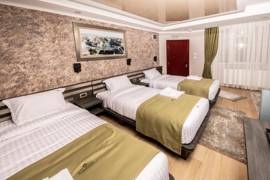 Postel nebo postele na pokoji v ubytování Hotel Novotheos