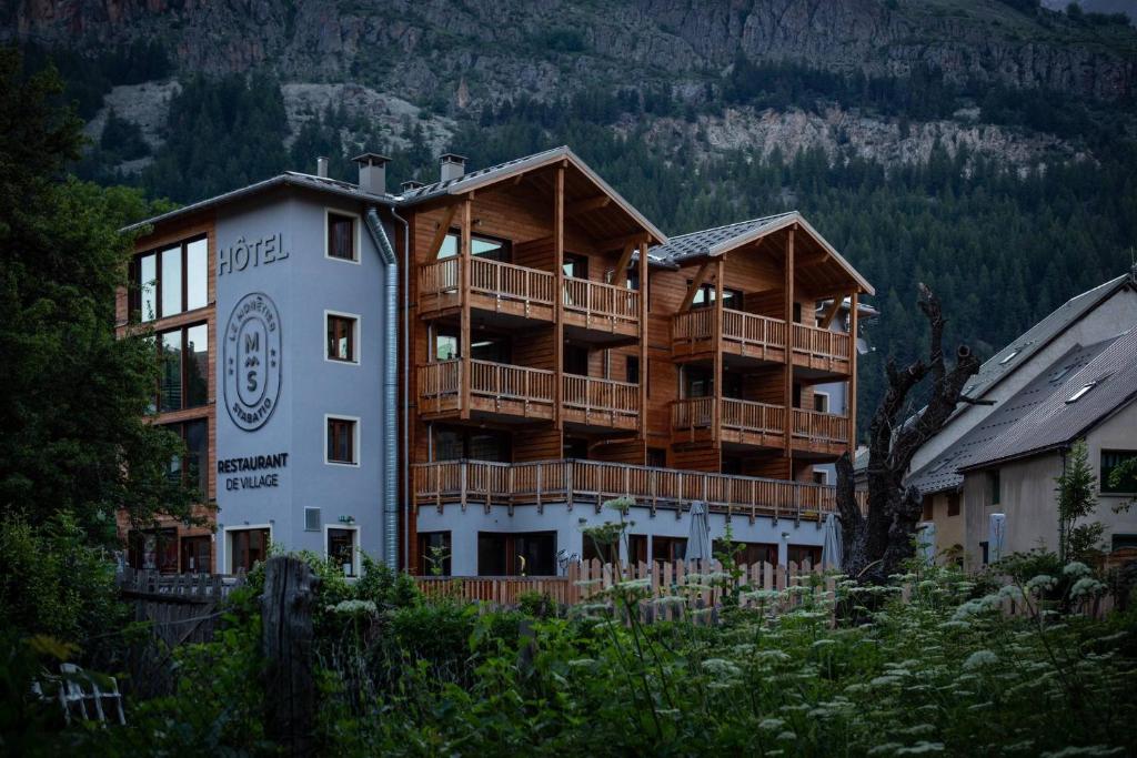 a large apartment building on the side of a mountain at Hôtel Restaurant Le Monêtier in Le Monêtier-les-Bains