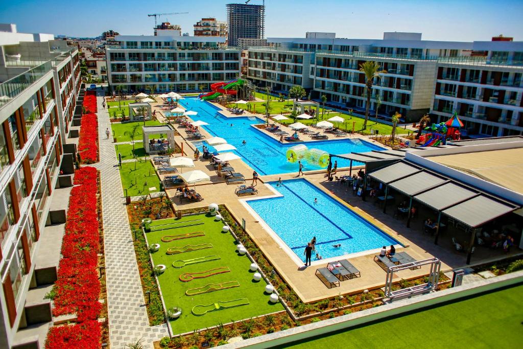 vista aerea su un'ampia piscina in un edificio di Courtyard Long Beach Holiday Resort a Iskele