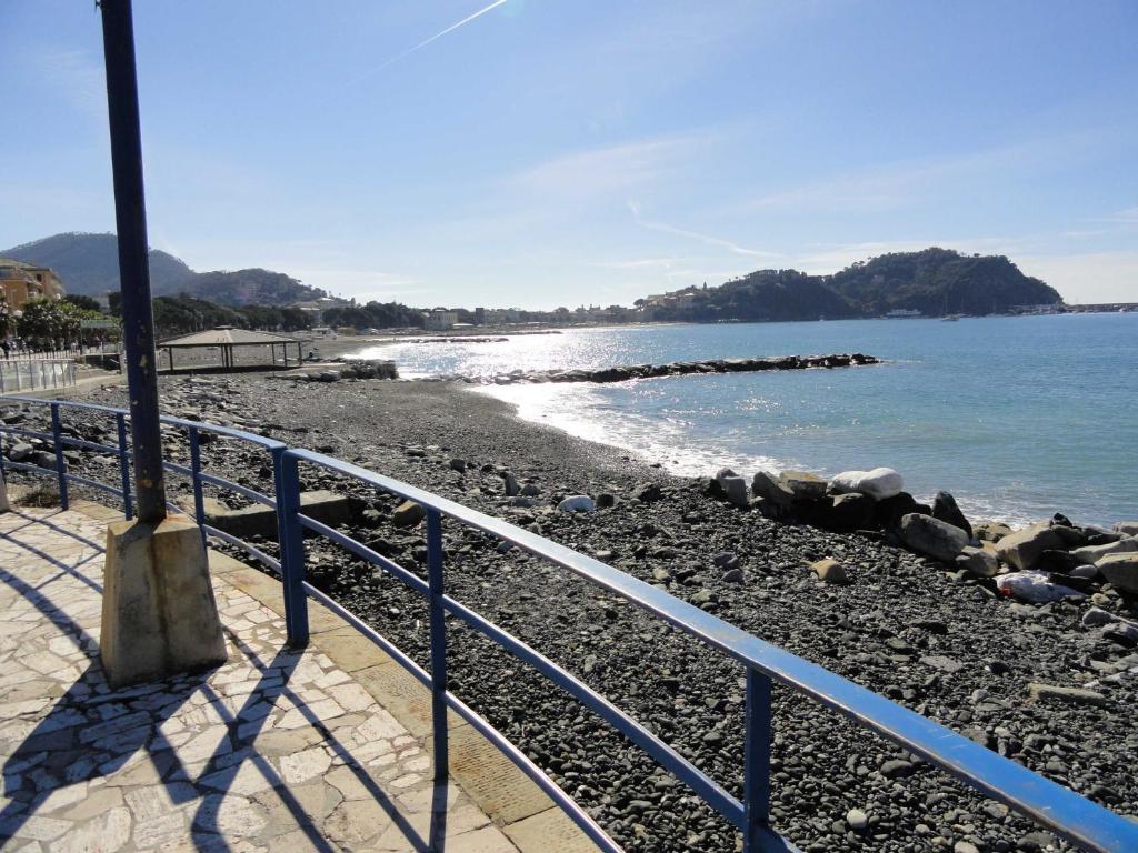 una spiaggia con ringhiera blu accanto all'acqua di Casa Ciabatta a Sestri Levante