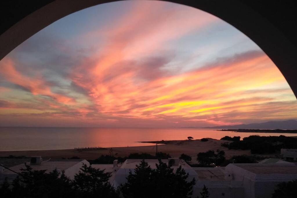 a view of a sunset from a window at Sarakiniko in Agiassos