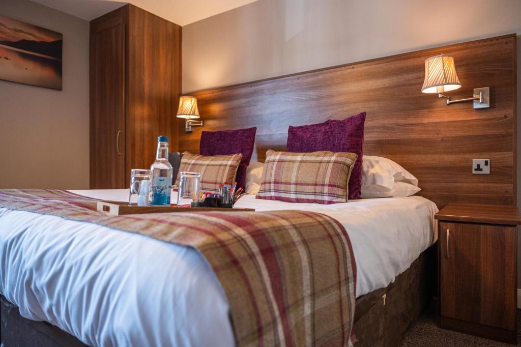 a bedroom with a large bed with a wooden headboard at Foundry 34 in Penrith