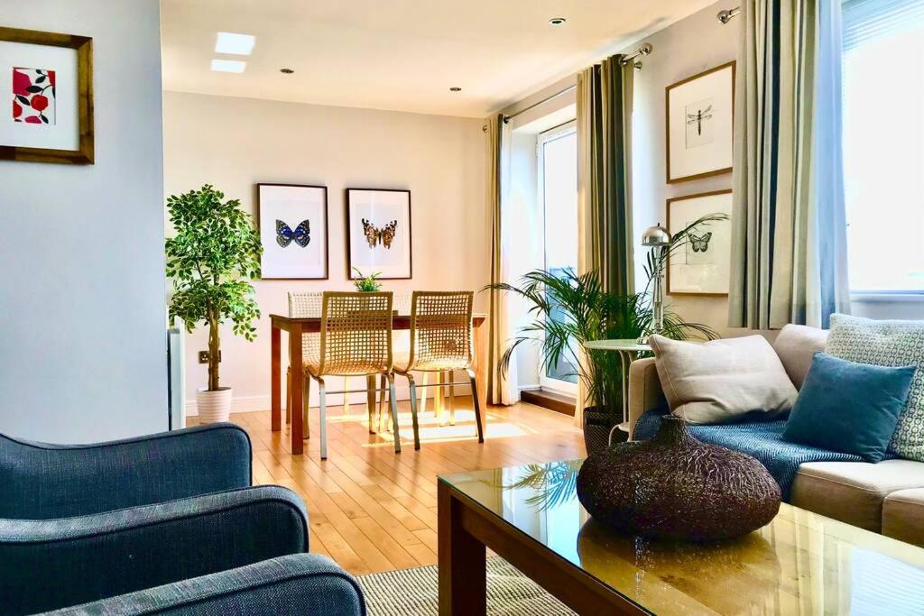 a living room with a couch and a table at Stylish Quayside 2 bed apartment with beautiful river views in Newcastle upon Tyne