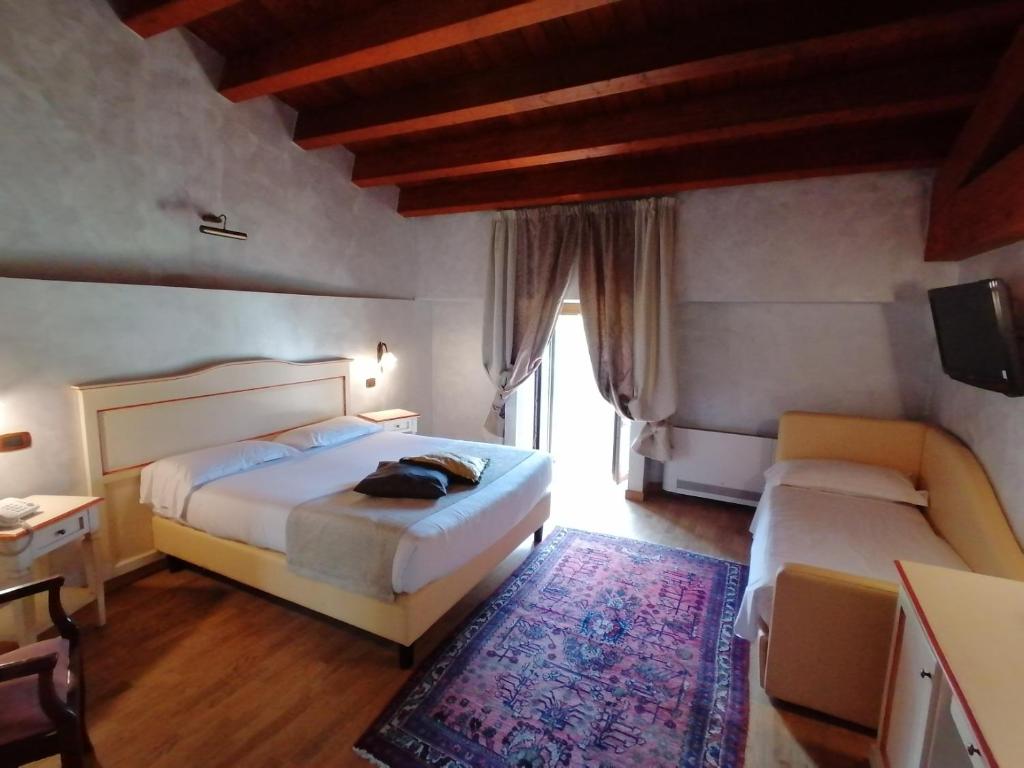 Postel nebo postele na pokoji v ubytování Relais Castrum Boccea