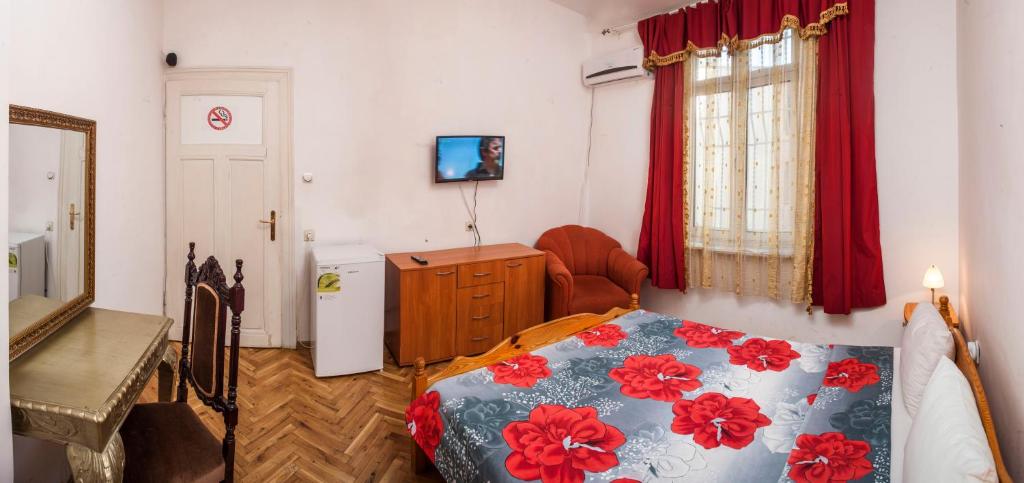 A bed or beds in a room at Central GuestHouse Five Corners