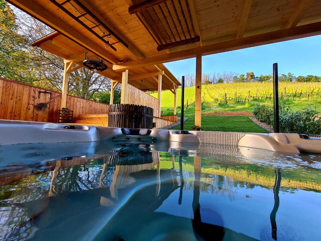 a swimming pool in a house with a view of a field at Ferienhaus Winzerhaus Südsteiermark in Leibnitz