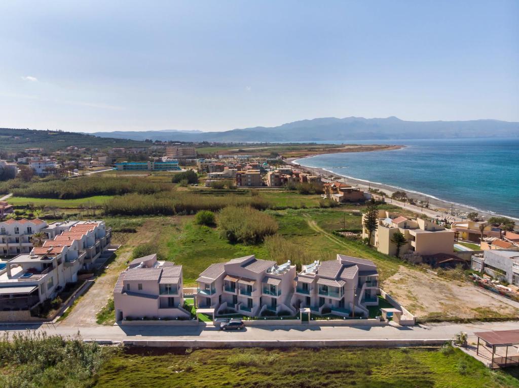 an aerial view of a beach with houses and the ocean at Aegean Breeze Luxury Apartments in Maleme
