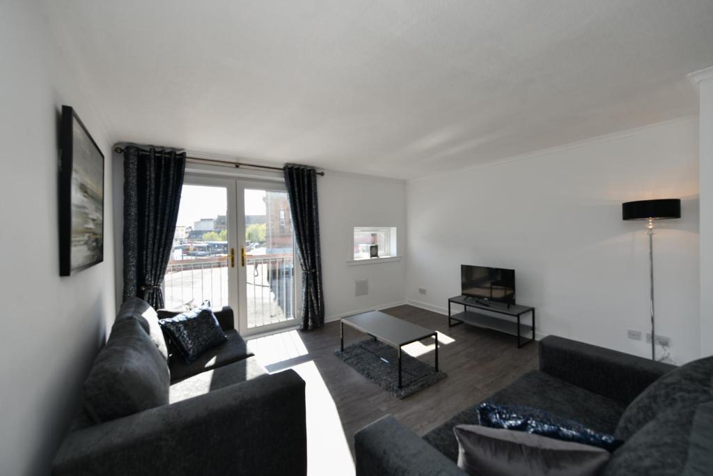 a living room with a couch and a table at Mews House in Ayr