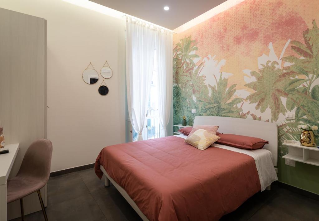 a bedroom with a bed with a red blanket at Casa dAvorio in Salerno