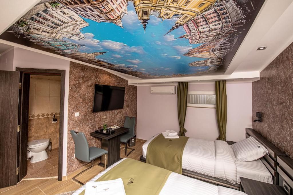 Postel nebo postele na pokoji v ubytování Hotel Novotheos