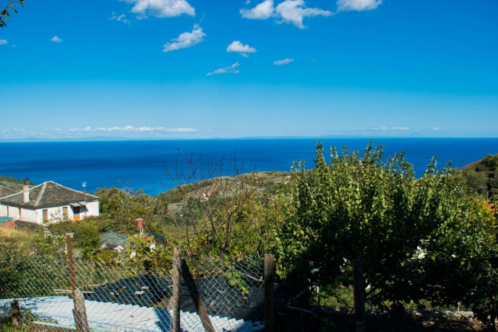 a house on a hill with the ocean in the background at Casa Levante in Keramídhion