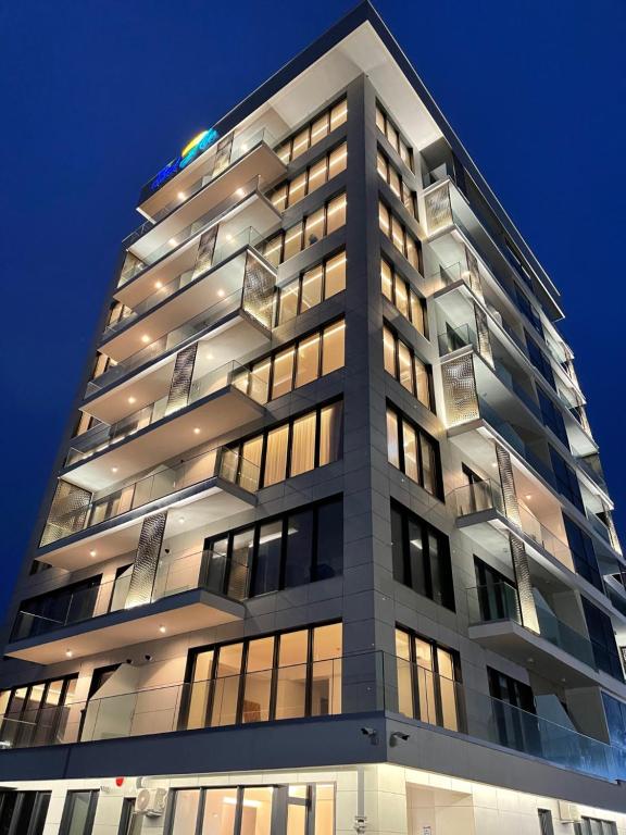 a tall building with many windows at night at Bel Air Apartments Mamaia Nord in Mamaia