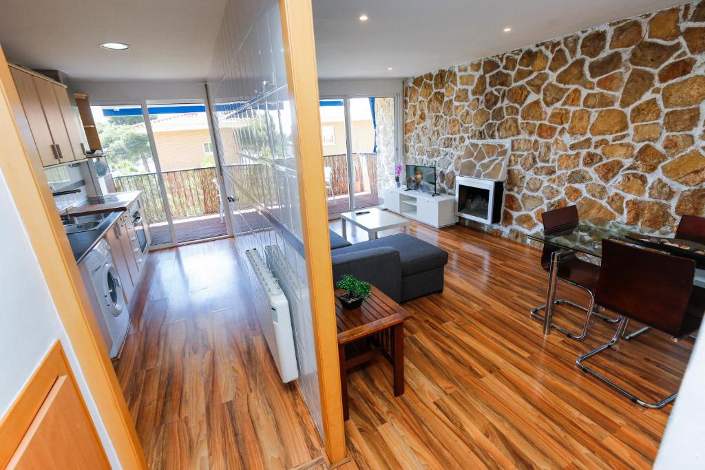 una gran sala de estar con una pared de piedra. en LifeWay CRANC Xperience by GuestWay, en Salou