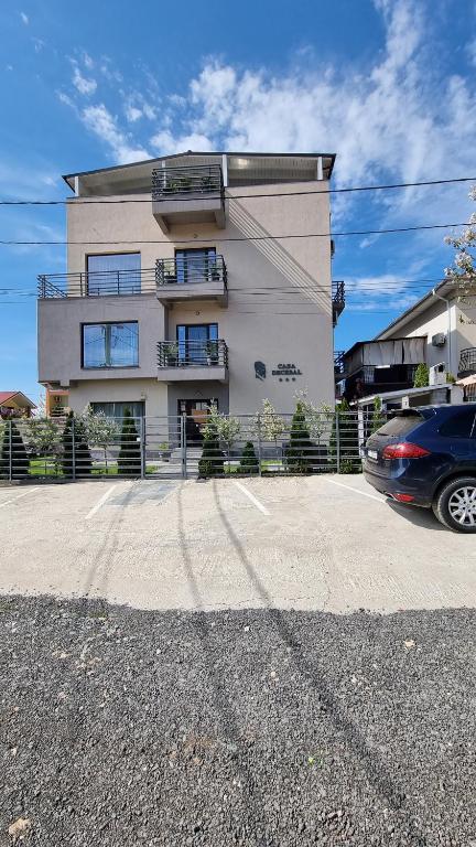 a building with a car parked in front of it at Casa Decebal in Eforie Nord