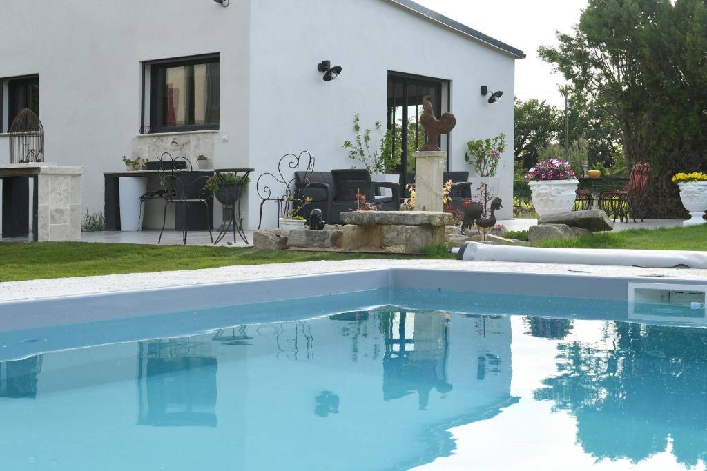 a house with a swimming pool in front of a house at Le Galinié Chic&#39;Art. Un bel Atelier avec Piscine in Carpentras