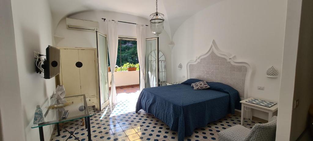 
a bedroom with a bed and a dresser at Casa Lucibello in Positano
