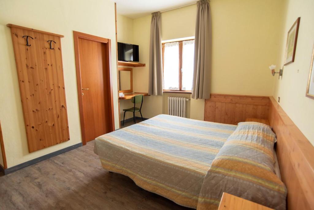 Posteľ alebo postele v izbe v ubytovaní Albergo Bucaneve