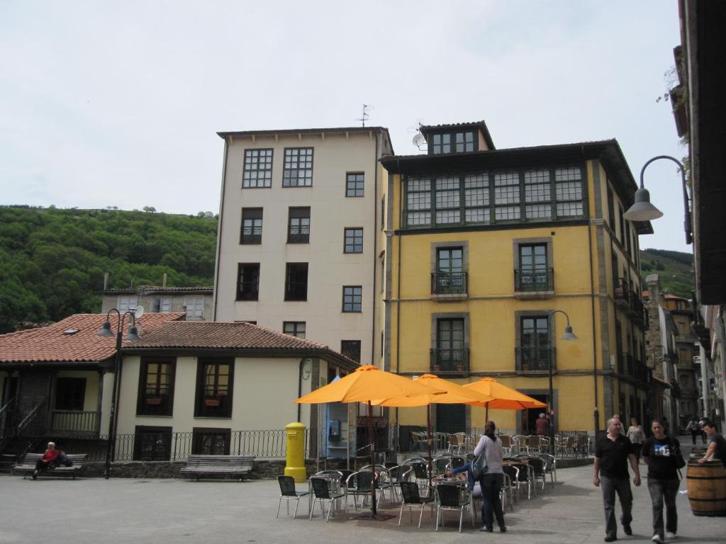 a group of people walking in front of a building at La Refierta in Cangas del Narcea