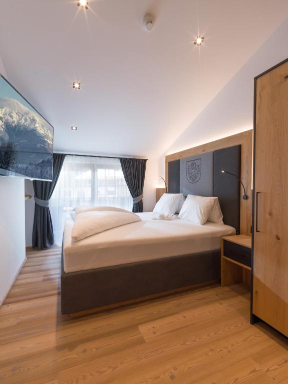 Rúm í herbergi á Dorfkaiser Appartements