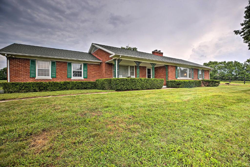 a red brick house with a large yard at Horse Country House, 6 Mi to KY Horse Park! in Lexington