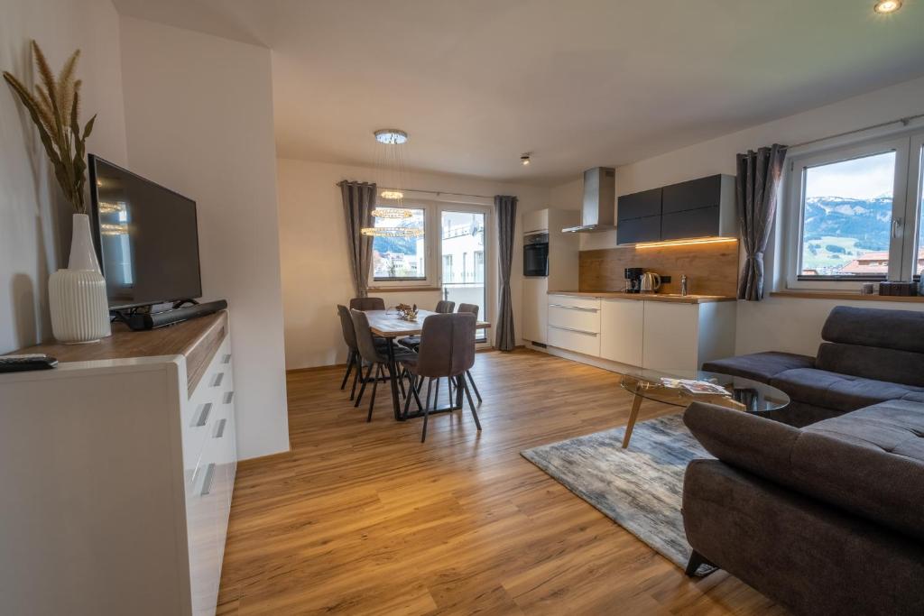 a living room and kitchen with a couch and a table at Apartment Nora in Ehrwald