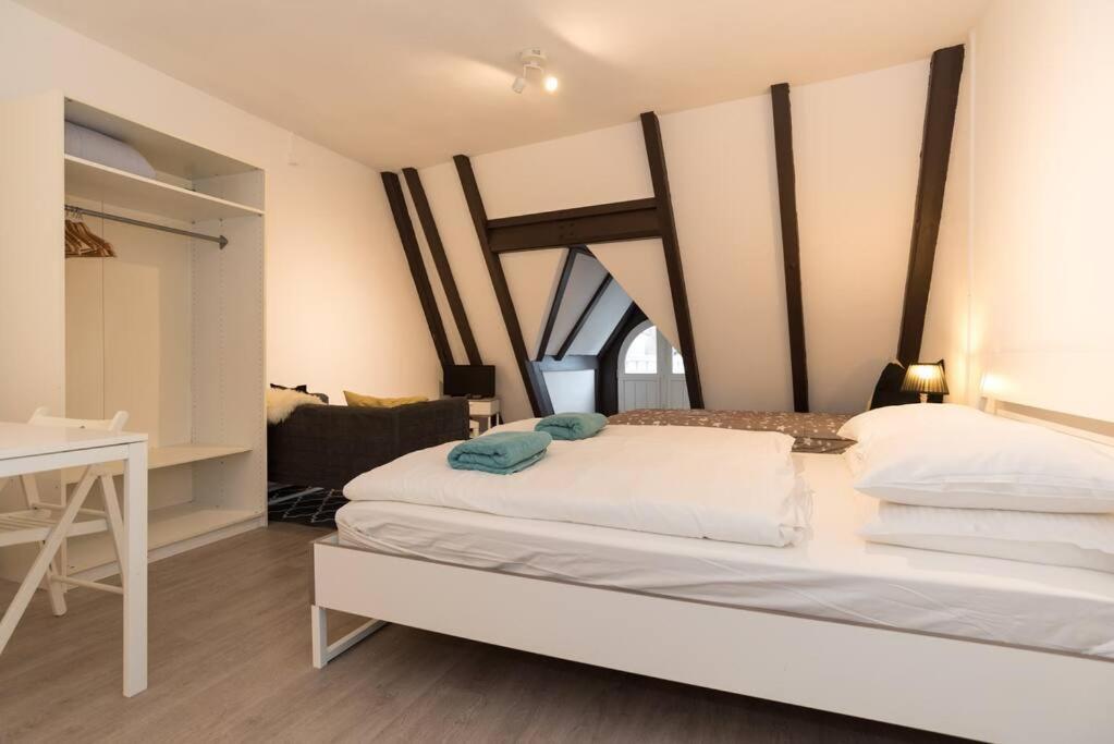 a bedroom with a bed and a desk in a room at RedLight District Smokers Friendly Private Studio in Amsterdam