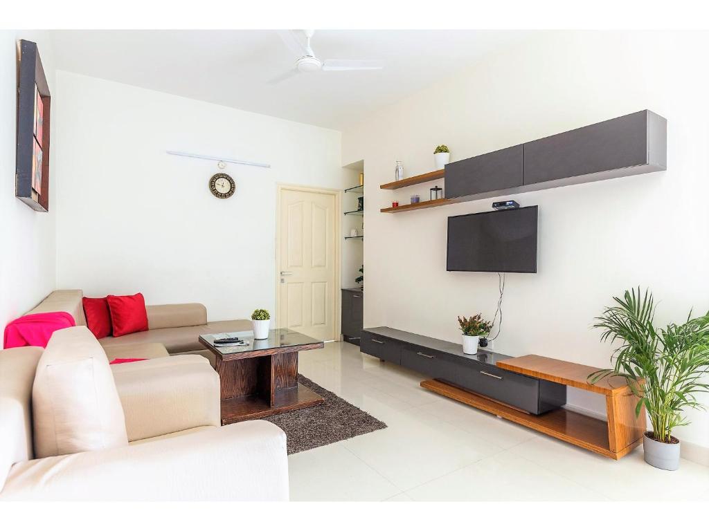 A television and/or entertainment centre at BluO 2BHK Hitech City - Gym, Terrace Garden, Lift